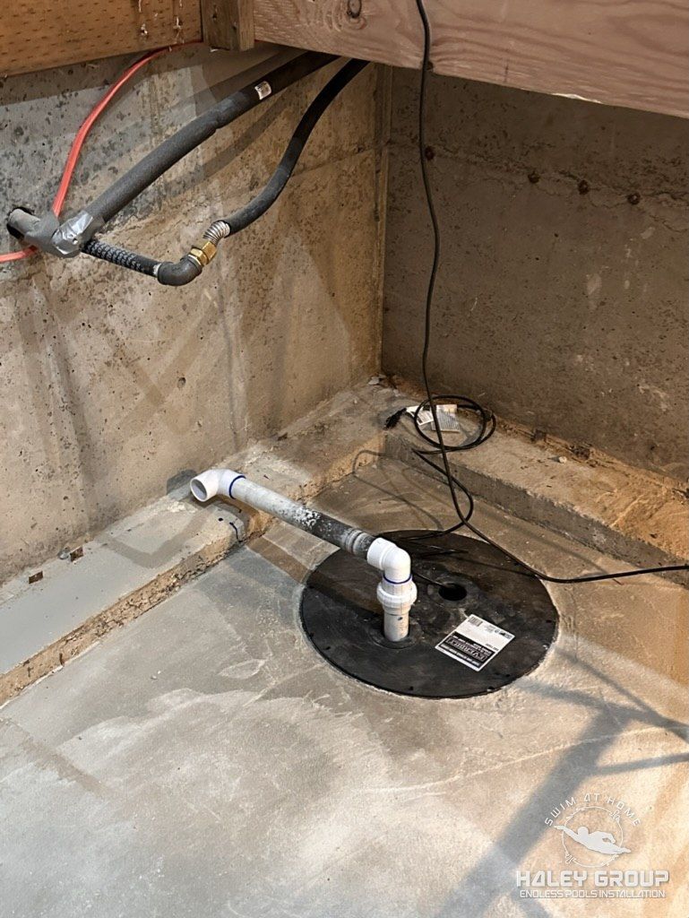 Sump pump plumbed through the cured concrete pad